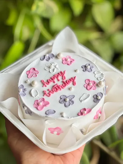 Another angle of the pastel floral bento cake, showcasing the flowers piped along the sides for a complete look.