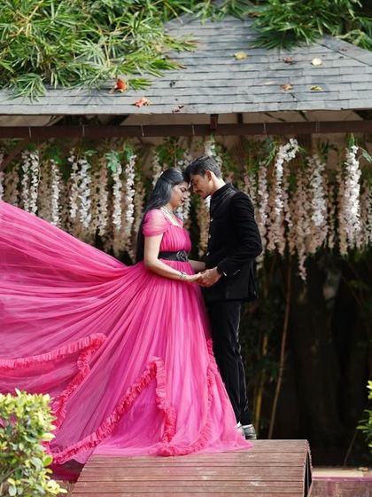 A romantic embrace in a garden gazebo. The "flying" trail of the magenta gown adds a touch of magic and drama to this pre-wedding photo.