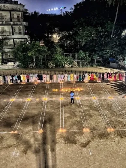 A single coach stands in the center of our maidan, surrounded by students. This image symbolizes the guidance and foundation we provide on the very ground that shapes our athletes.