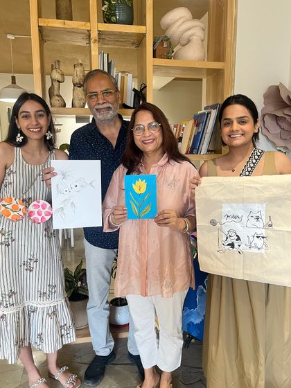 A beautiful multi-generational family portrait after a successful art session. Everyone from daughters to grandparents got involved in painting and crafting.