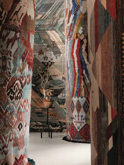 We believe walls are storytellers. This installation demonstrates how textiles can transform a space, using intricately designed rugs as vertical art to create an immersive corridor of pattern, texture, and color that envelops the viewer.