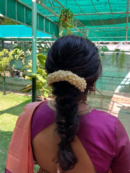 A simple and pretty messy fishtail braid, adorned with malli poo. This is a great hairstyle for a more casual, outdoor event.