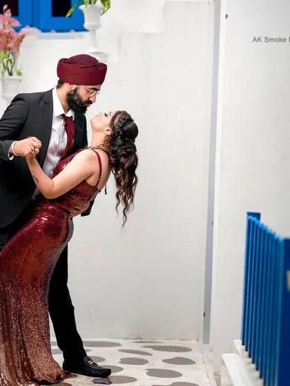 Your pre-wedding shoot should reflect your personality. For this fun-loving couple, we found a Santorini-themed location in Bangalore and captured their playful dynamic with a spontaneous dance dip.