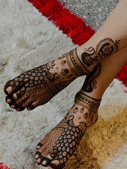 Another angle of the full-coverage peacock foot design, showing the intricate details on the toes and ankle.