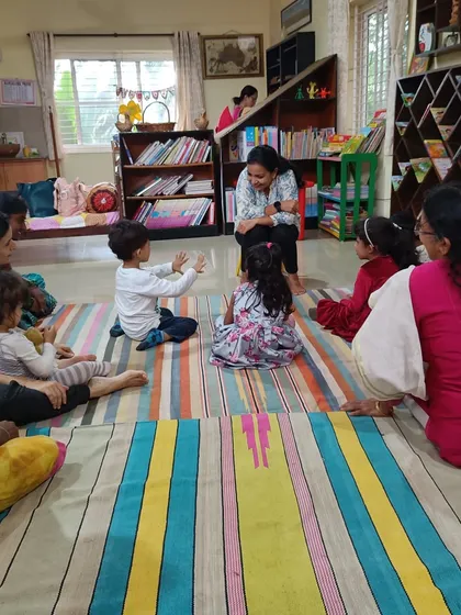A child interacts with the storyteller, a common and encouraged part of our sessions.