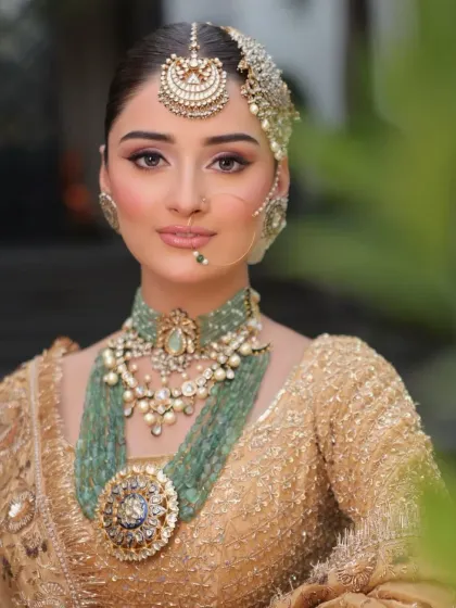 The beauty is in the details. This close-up highlights the exquisite craftsmanship of the bridal jewelry I selected, from the layered emerald necklaces to the intricate Polki maang tikka and passa, completing the golden bridal ensemble.