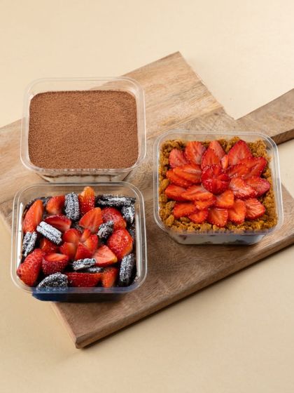 Our customisable set of three desserts is the perfect way to try a variety of my signature creations. Pictured here are our Tiramisu, Strawberry Oreo, and Strawberry Biscoff Cheesecake tubs.