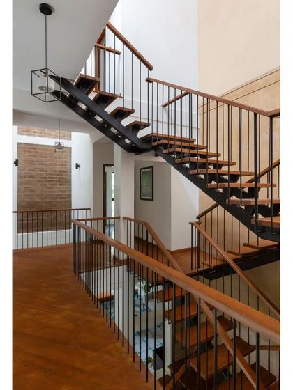 The new staircase in the Hyderabad home is a central feature connecting the floors. By replacing an older, bulkier staircase, we opened up the interior volume, creating a sense of spaciousness and improving the flow between living areas.