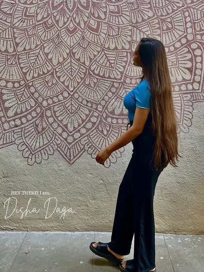 A moment of reflection next to one of my wall murals. Each piece is a reminder of how far I've come on this artistic journey.