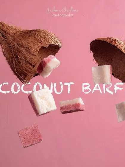 A creative and playful shot of coconut barfi, an Indian sweet. I used levitation photography techniques to make the sweets appear as if they are flying out of a cracked coconut.