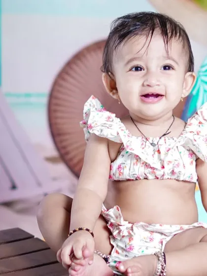 A beautiful, happy close-up portrait that perfectly captures the joy of a first birthday.