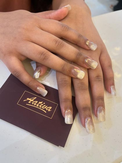A full view of the stunning gold and white cat eye nails, a perfect example of our custom artistry.