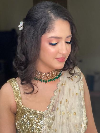 A golden glow for this beautiful client in a chikankari lehenga. The soft, shimmery makeup and elegant hairstyle looked absolutely mesmerizing.