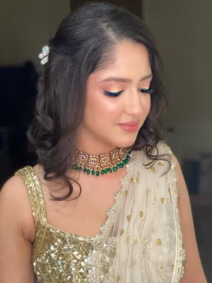 A golden glow for this beautiful client in a chikankari lehenga. The soft, shimmery makeup and elegant hairstyle looked absolutely mesmerizing.