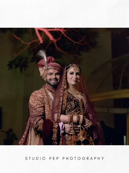 A beautifully composed wide shot of the couple, framed by modern architecture and purple lighting.