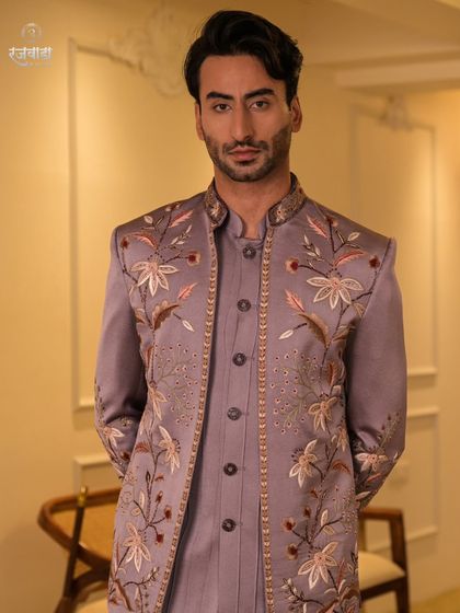 A formal portrait pose in the mauve Jodhpuri, demonstrating its sharp tailoring and regal posture. This is an ideal choice for a groom's engagement or Sangeet ceremony.