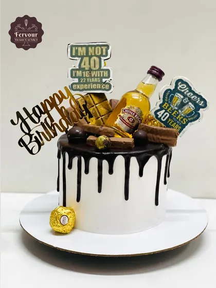 A 40th birthday cake for a husband, featuring a miniature bottle of Chivas Regal, chocolate drip, and funny toppers about his age and experience.