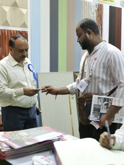 Here I am, interacting with a visitor at our MATECIA stall, exchanging cards and discussing potential collaborations.