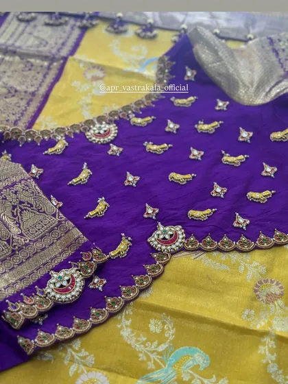 The full layout of the purple and yellow half-saree set, displaying the heavily embroidered blouse and the complementary silk fabrics.