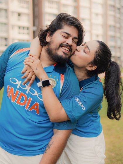 A sweet kiss on the cheek shows their affectionate bond. This photo highlights the tender moments that can be found even in a fun, activity-based pre-wedding shoot.