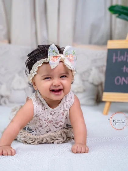 Halfway to one and full of smiles. This baby girl's infectious giggle is the highlight of her six-month sitter session.