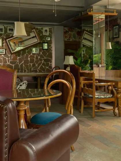 The mix of seating at Echoes, from leather armchairs to wooden dining chairs, creates a dynamic and eclectic environment. This approach avoids uniformity and enhances the feeling of a collected, personal space.
