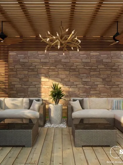 A cozy rooftop lounge area designed for relaxation. This outdoor living room features custom U-shaped seating, weather-resistant fabrics, and a stone accent wall, creating a perfect retreat.