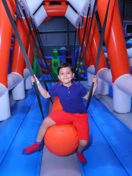 Riding the wrecking ball! This inflatable swing is a favorite in our obstacle course area, offering a fun way for kids to test their balance and have a great time doing it.
