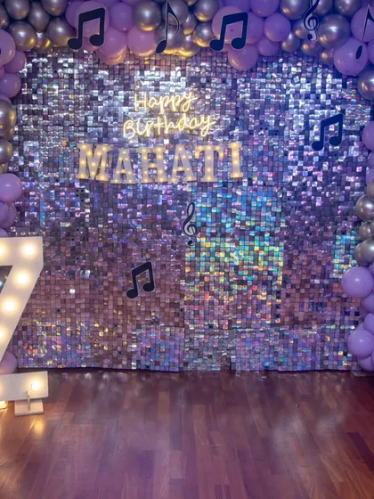 The complete look for Mahati's disco party. The shimmering sequin wall, marquee number, and musical note balloon arch created a stunning backdrop for the celebration.