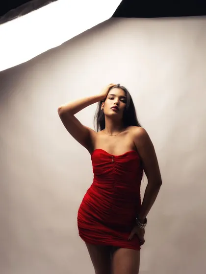 A powerful and confident pose, with the studio light creating a beautiful gradient on the background.