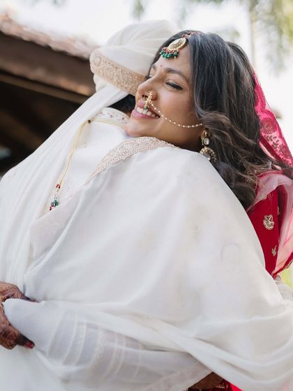 A hug filled with pure, unadulterated joy. Sakshi’s radiant smile as she embraces her partner is a beautiful, candid expression of her happiness on their wedding day.