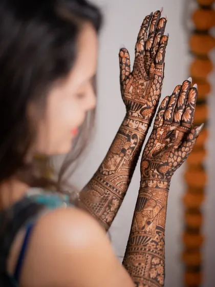 A close-up shot focusing on the intricate patterns of the bridal mehendi. These detailed shots are a beautiful way to remember the artistry.