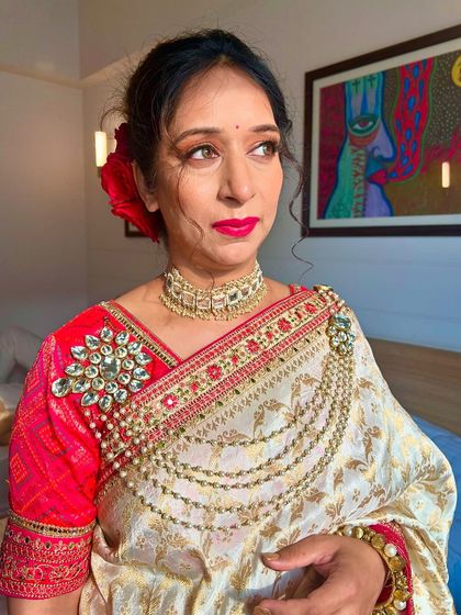 An elegant party makeup look for this client. Her beautiful saree with pearl detailing was the inspiration for her luminous makeup and classic red lip.
