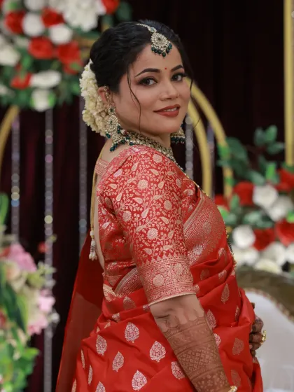 A side profile highlighting the intricate hairstyle and the glow of her skin under the event lighting.