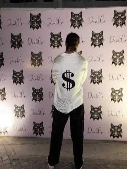 For the man who isn't afraid to make a statement, I designed this custom white party shirt. The bold dollar sign motif on the back is a perfect example of how we can bring any unique idea to life.