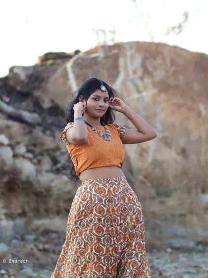 Another angle of the bohemian look, capturing a candid moment. The natural lighting and environment add to the free-spirited feel of the shoot.