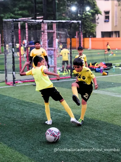 A competitive moment in a small-sided game, where players learn to work together to win the ball.