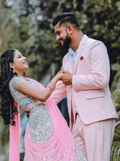 I love creating perfectly coordinated looks. Here, my client looks dapper in a custom pastel pink suit, perfectly complementing his partner's beautiful pink and silver lehenga. It's all about capturing your connection in style.