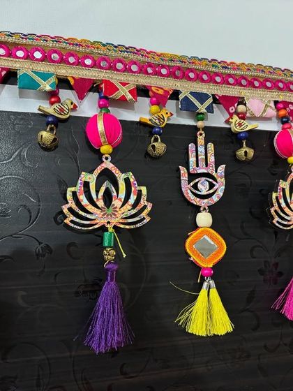 Another view of the sold 'Shubh Toran', focusing on the vibrant tassels and the hamsa hand, a symbol of protection.