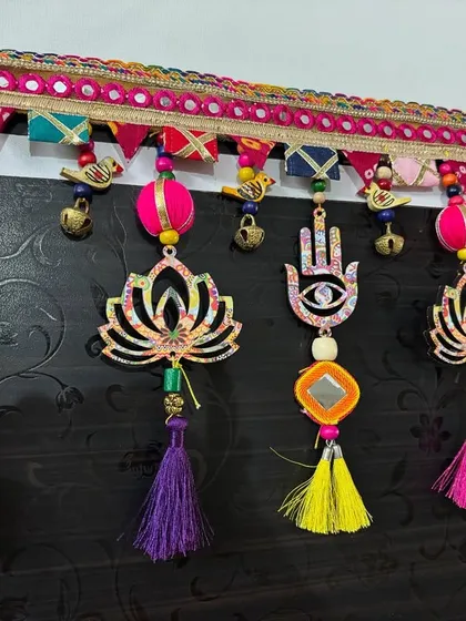 Another view of the sold 'Shubh Toran', focusing on the vibrant tassels and the hamsa hand, a symbol of protection.