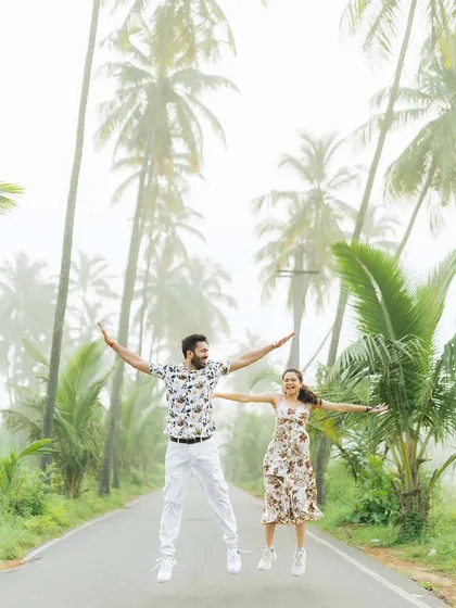A fun, energetic jump shot on a foggy road lined with palm trees in Goa. We love capturing these spontaneous moments of pure happiness and excitement.