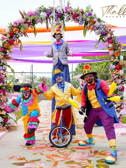 Fun and fantasy come alive with our carnival themed events. Here, performers on stilts and unicycles greet guests under a vibrant floral arch, setting a playful and festive tone from the very beginning.