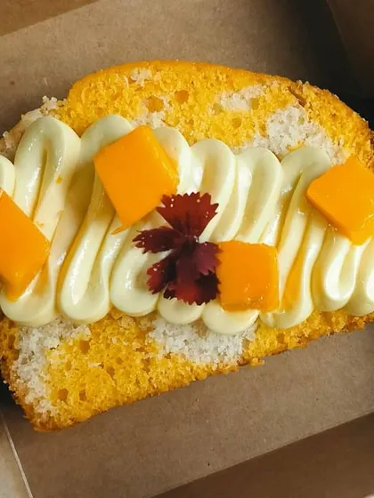 For parties and bulk orders, I offer individual cake slices. Here are two of my popular flavors: the tropical Coconut Mango and the rich Choco Pistachio marble cake slices.