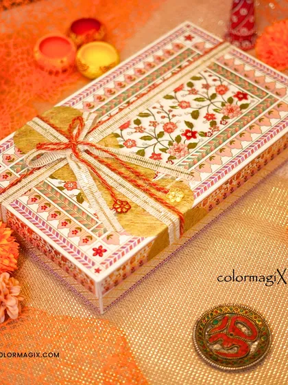 A close-up of our intricately designed floral print Diwali box. The traditional patterns and rich colors make it a beautiful keepsake long after the sweets are gone.