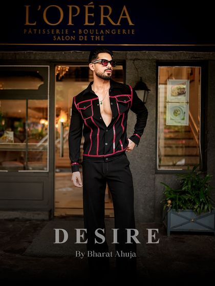 Dressed in desire, walking with confidence. This full-length shot captures the sharp, unapologetic style of the black and red piped jacket.