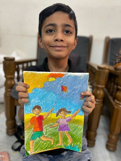 An older student's detailed Makar Sankranti drawing, showing children flying kites. This piece captures the festive spirit and is a great example of memory drawing.