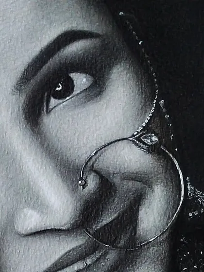 A macro shot focusing on the eye and traditional nose ring of the bride. This close up view highlights the detailed pencil work required to make the jewelry look realistic.