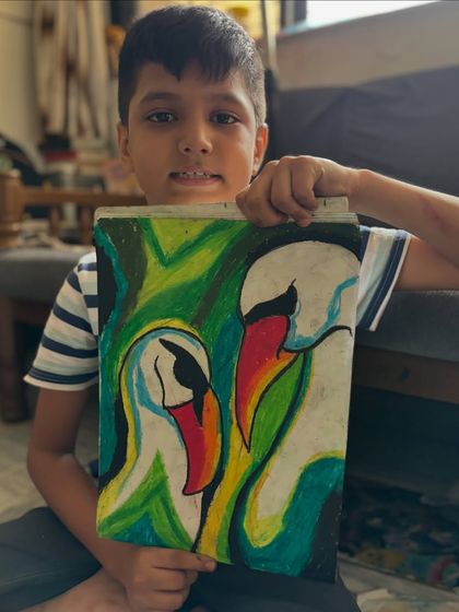 A young artist presents his graceful swan drawing, filled with a burst of colour. We explore different ways to use oil pastels to create movement and life in our artwork.