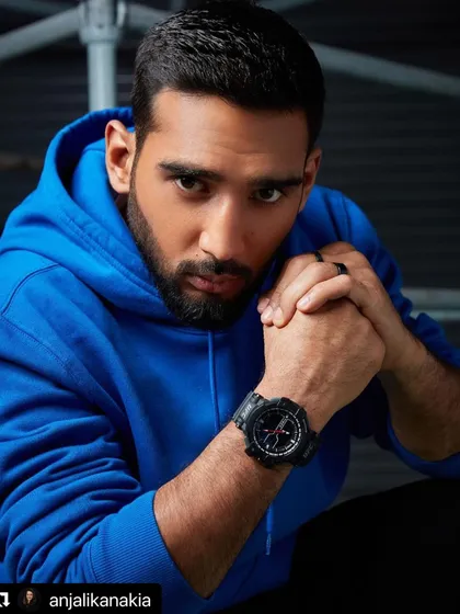 A powerful portrait from the Timex UFC campaign. The model is styled in a simple blue hoodie, with the intense lighting and his direct gaze creating a mood of strength and focus, letting the rugged watch stand out.