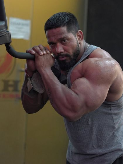 A close-up showing the arm and shoulder size. This is the result of consistent, heavy training.